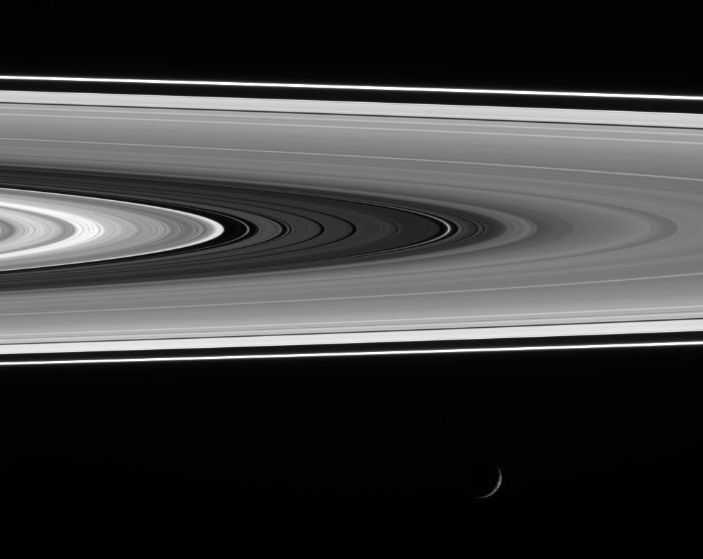 A recently discovered diffuse ringlet shines brightly in the Cassini Division as Mimas cruises past at bottom