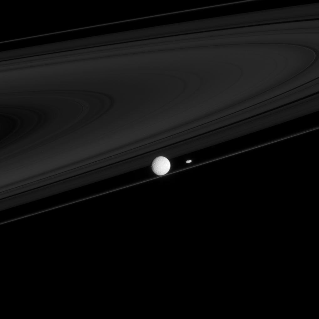 Two moons that have profound impacts on the rings, Mimas and Prometheus, are seen here with the F ring.