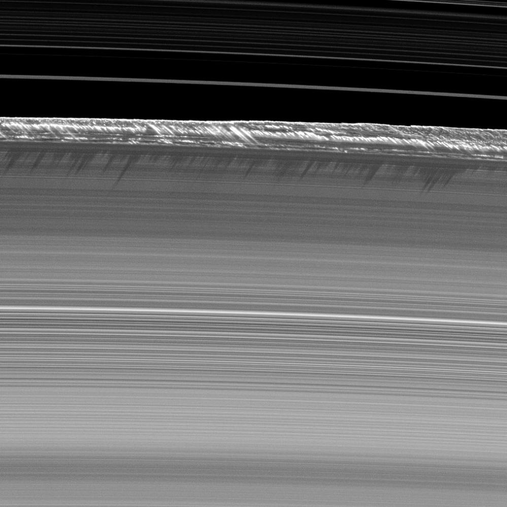 Vertical structures, among the tallest seen in Saturn's main rings, rise abruptly from the edge of Saturn's B ring to cast long shadows on the ring in this image taken by NASA's Cassini spacecraft two weeks before the planet's August 2009 equinox.