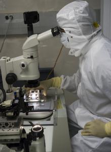 A researcher examining a 
Stardust aerogel tile under a stereo microscope.