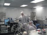 Photo of scientists conferring in the clean room