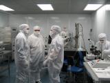 Photo of scientists conferring in the clean room