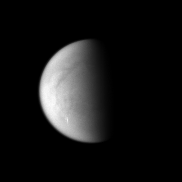 Cloud streaks stand out on Saturn's largest moon, Titan.
The tropospheric clouds seen in the lower left of the image are located at 45 to 55 degrees south latitude on Titan, and the streaks of the clouds are oriented east-west. This view looks toward the south pole of Titan.