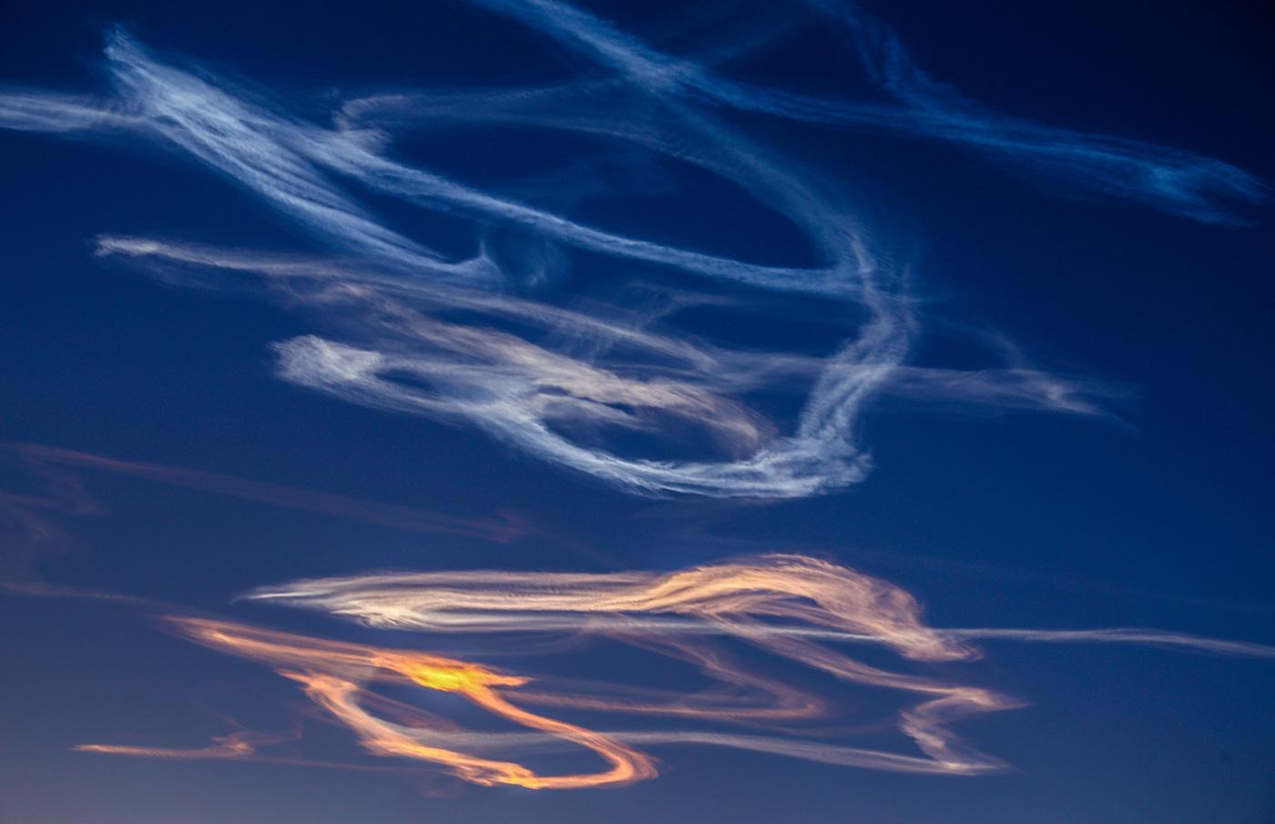 Trails in the sky that are remnants of a meteor entering Earth's atmosphere.