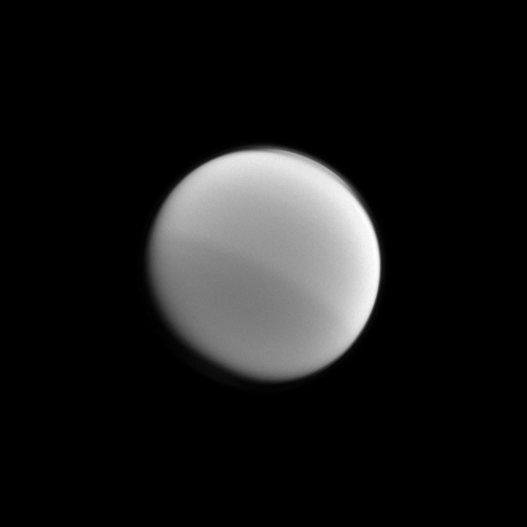 Light and dark halves of Titan are visible in this Cassini image that illustrates the seasonal changes in the northern and southern hemispheres. Image taken on Jan. 31, 2012.