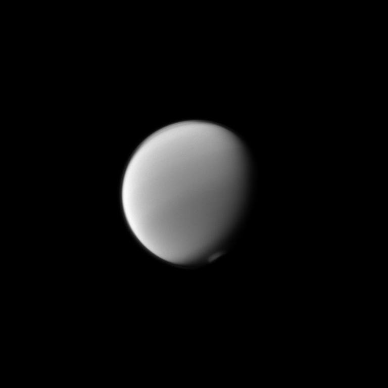 Titan's atmosphere puts on a display with the detached haze to the north (top of image) and the polar vortex to the south. Image released Jan. 13, 2014.