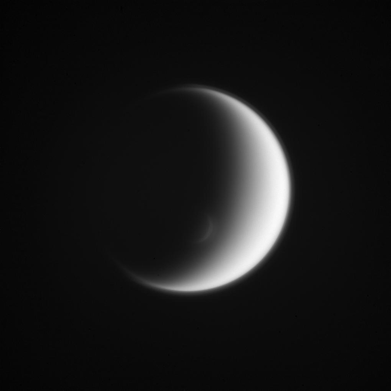 Titan's south polar vortex mimics the moon itself, creating an elegant crescent within a crescent. Situated above the surrounding polar atmosphere, the raised walls along the sunward side of the vortex just catch the grazing sunlight, creating a crescent of its own.