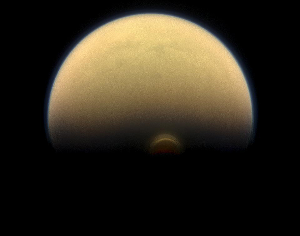 Slipping into shadow, the south polar vortex at Saturn's moon Titan still stands out against the orange and blue haze layers that are characteristic of Titan's atmosphere. Full image and caption ›