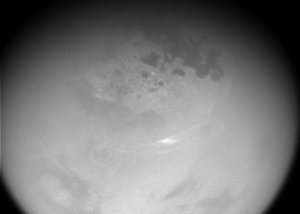 Floating high above the hydrocarbon lakes, wispy clouds have finally started to return to Titan's northern latitudes.
