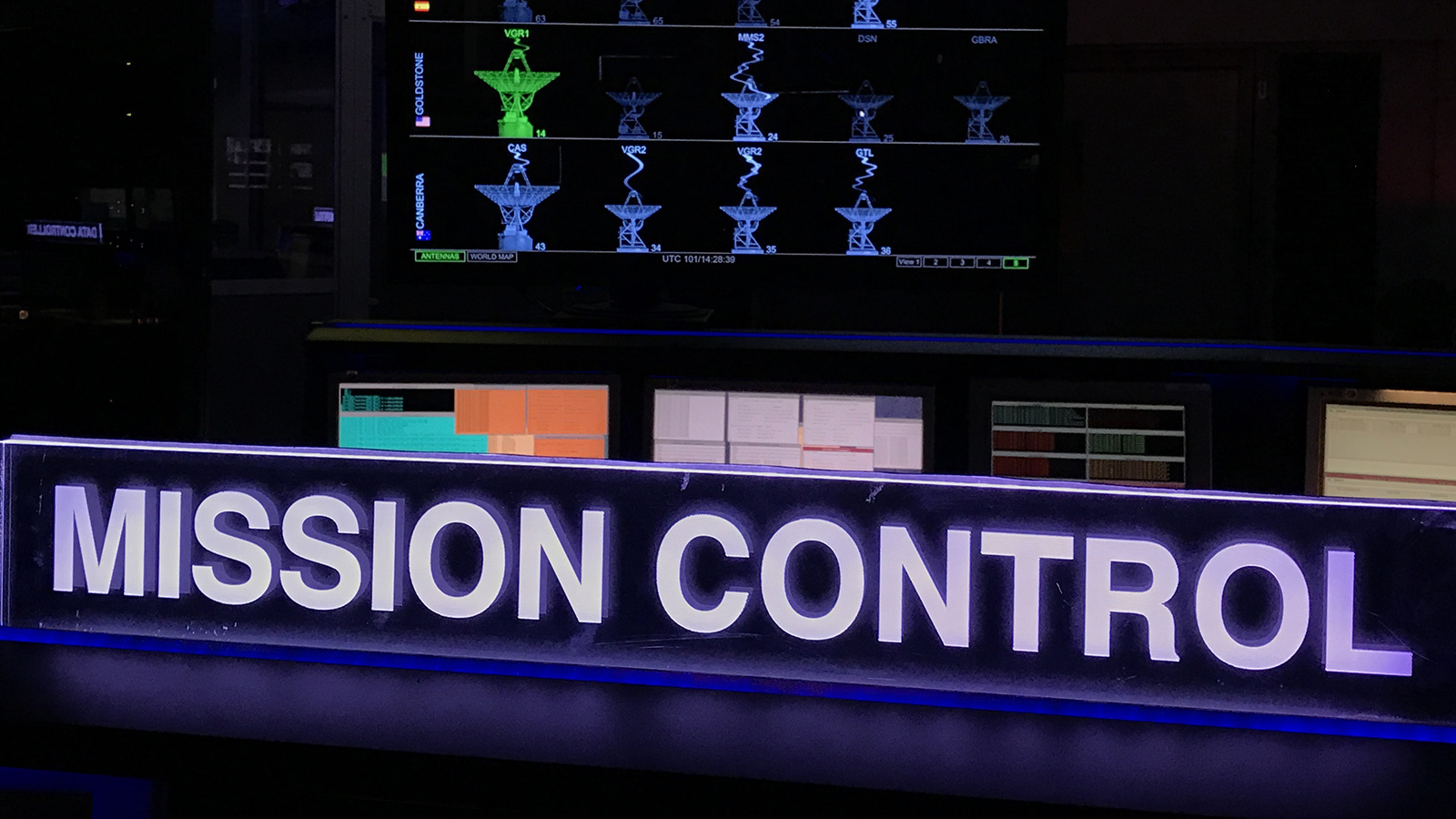 Color image of mission control showing computer screens.