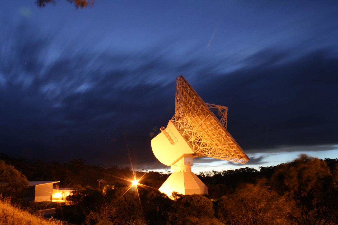Color image of giant antenna at night. 