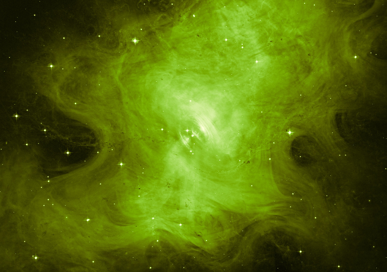 Hubble image of a greenish blob that is actually the Crab Nebula