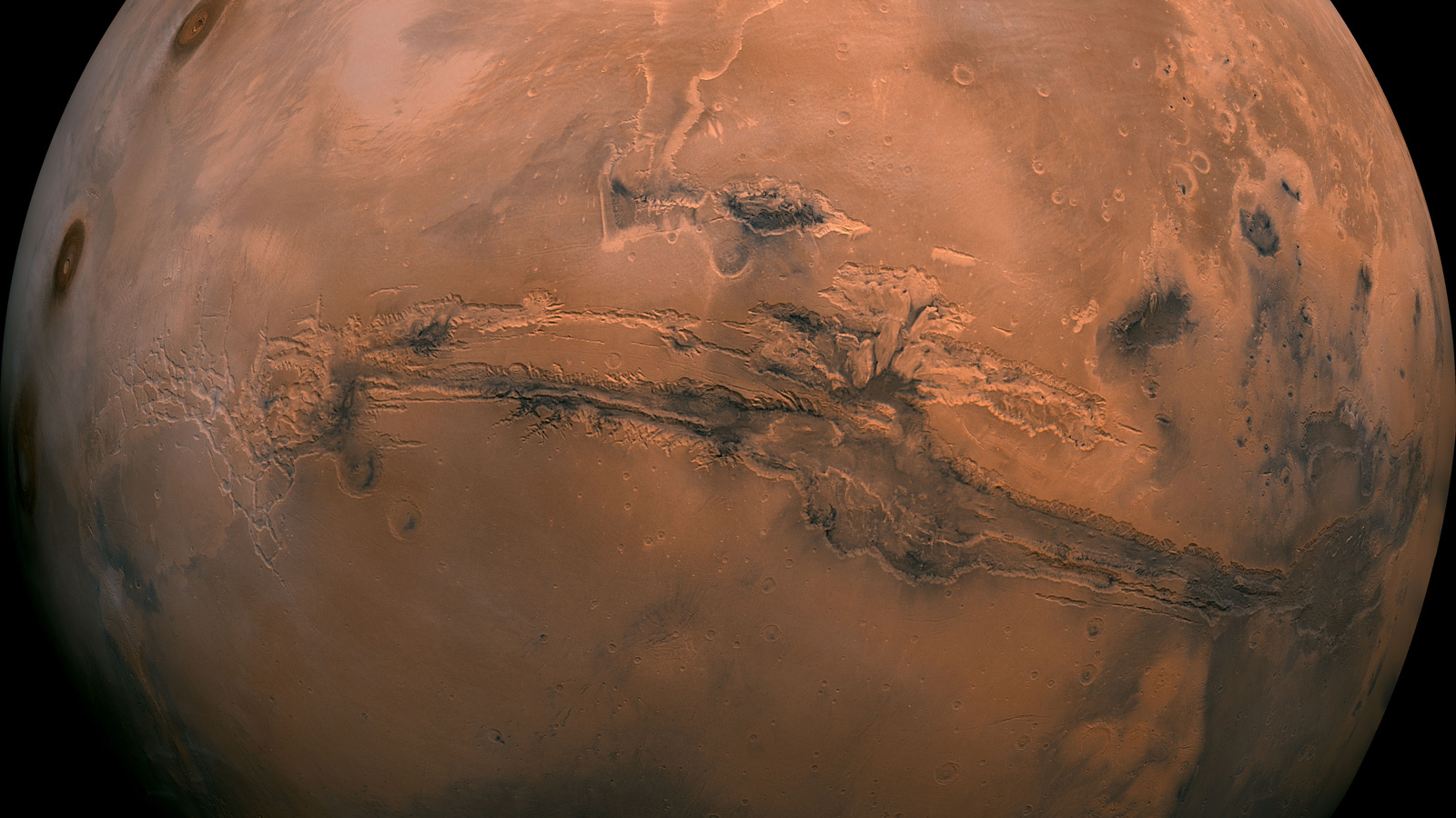 This mosaic of Mars is a compilation of images captured by NASA's Viking Orbiter 1. The center of the scene shows the entire Valles Marineris canyon system, over 3,000 km long and up to 8 km deep, extending from Noctis Labyrinthus.