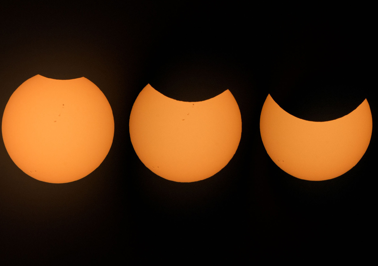 Images of the Sun in three different stages of an eclipse.