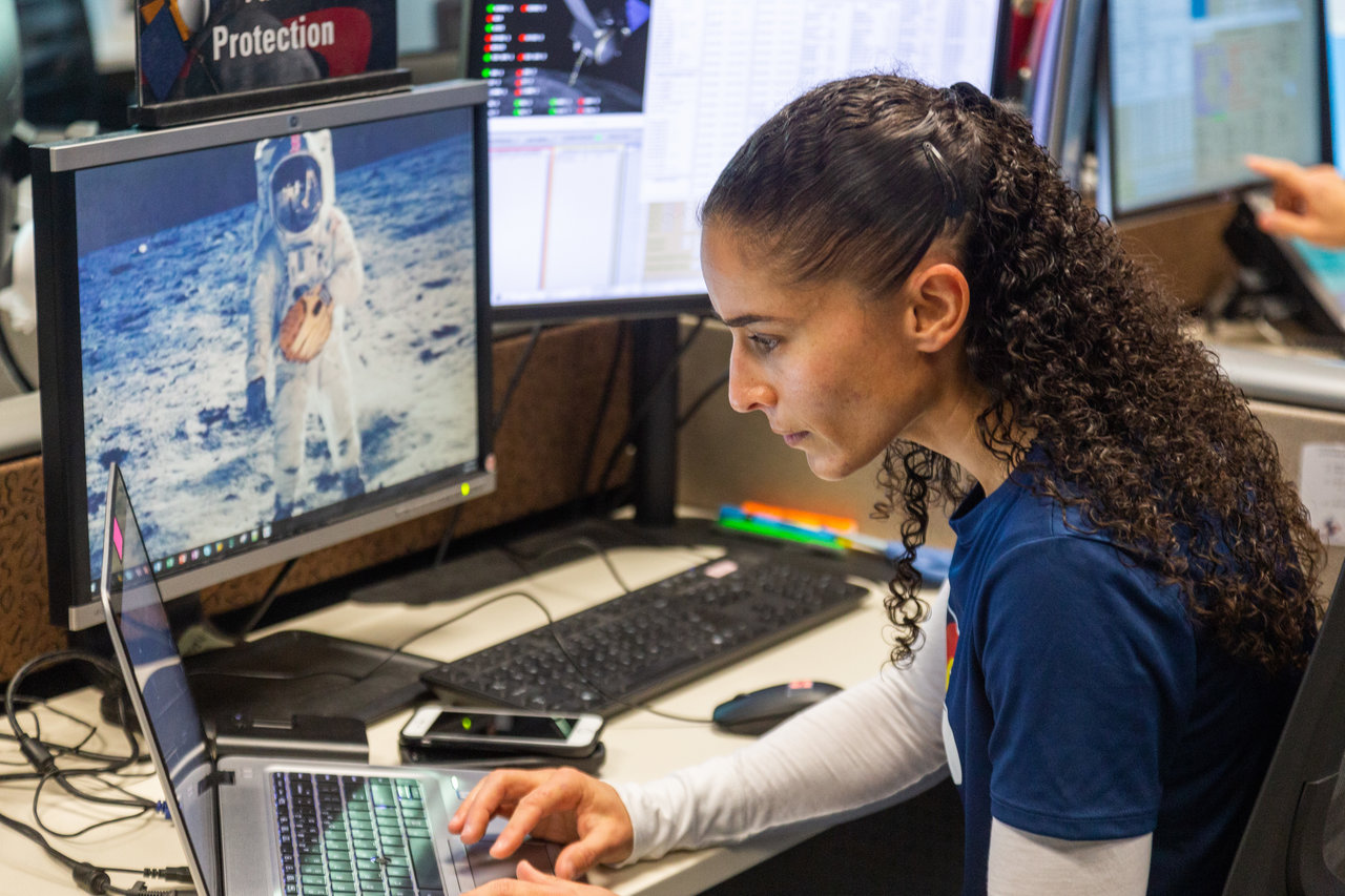 Woman watching computer monitor in mission control