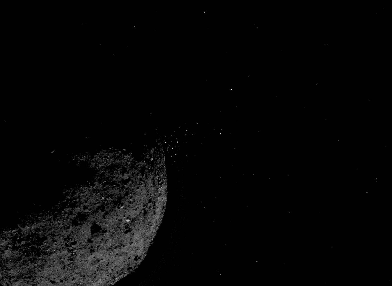 rocky asteroid ejecting small particles into space