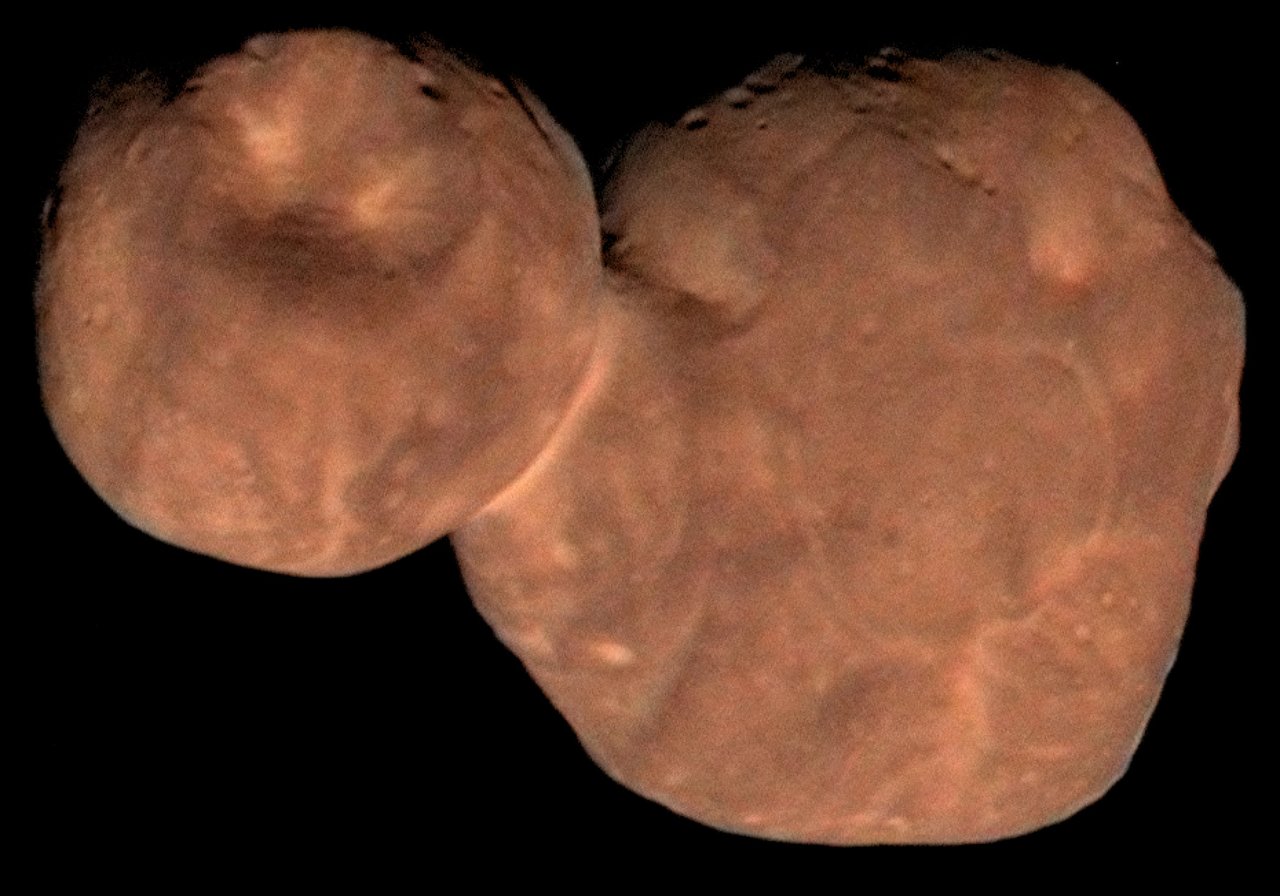 two-lobed, reddish, cratered object against dark space