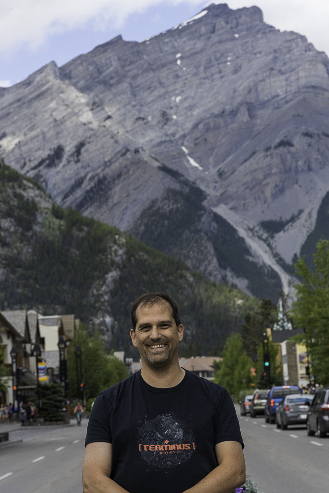 image of smiling man in street with mountains in the background