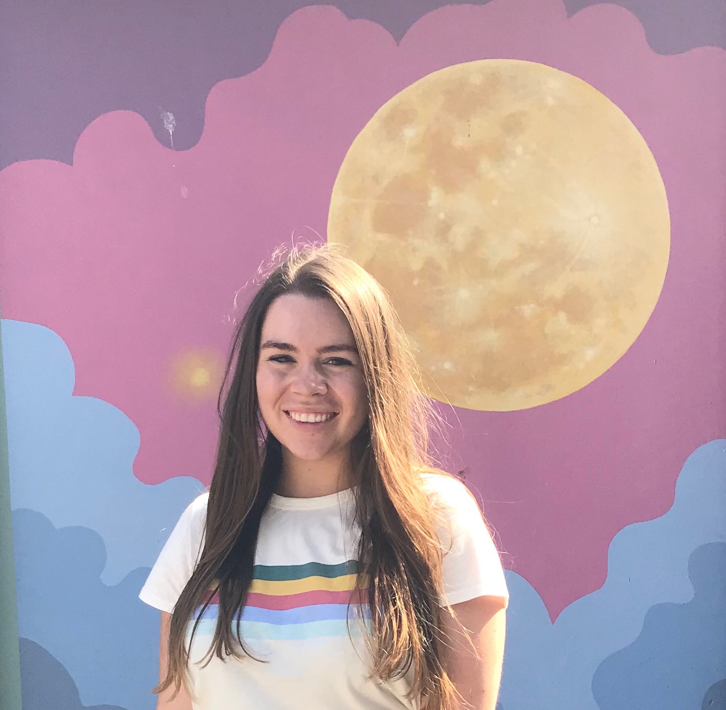Jordan in front of a colorful Moon backdrop.