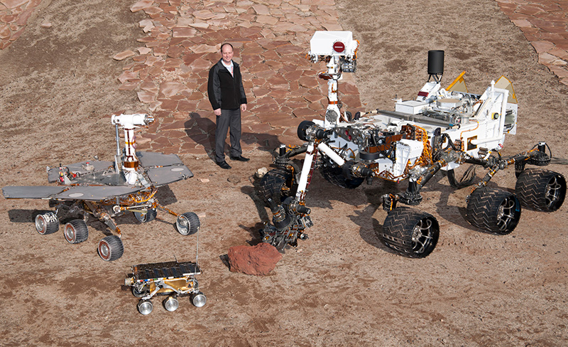 Jordan Evans with rovers in the Mars Yard at JPL
