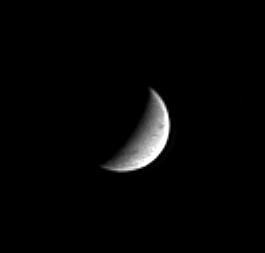 Black and white image of the crescent of Saturn's icy moon Enceladus.