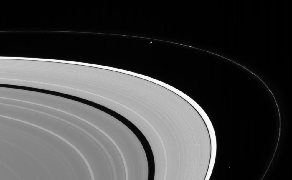 an image of Saturn's rings with the moons Epimetheus and Atlas in the background