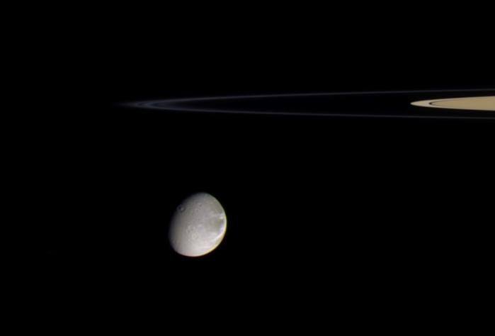 Dione with rings behind