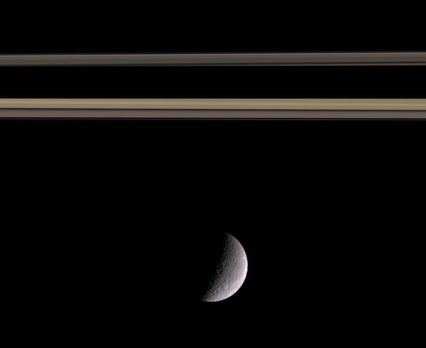 Rhea near a part of Saturn's rings