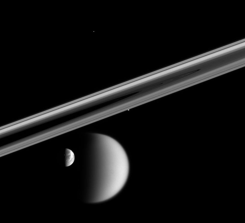 Near-alignment of four of Saturn's moons: Titan, Dione, Prometheus and Telesto near a portion of the rings