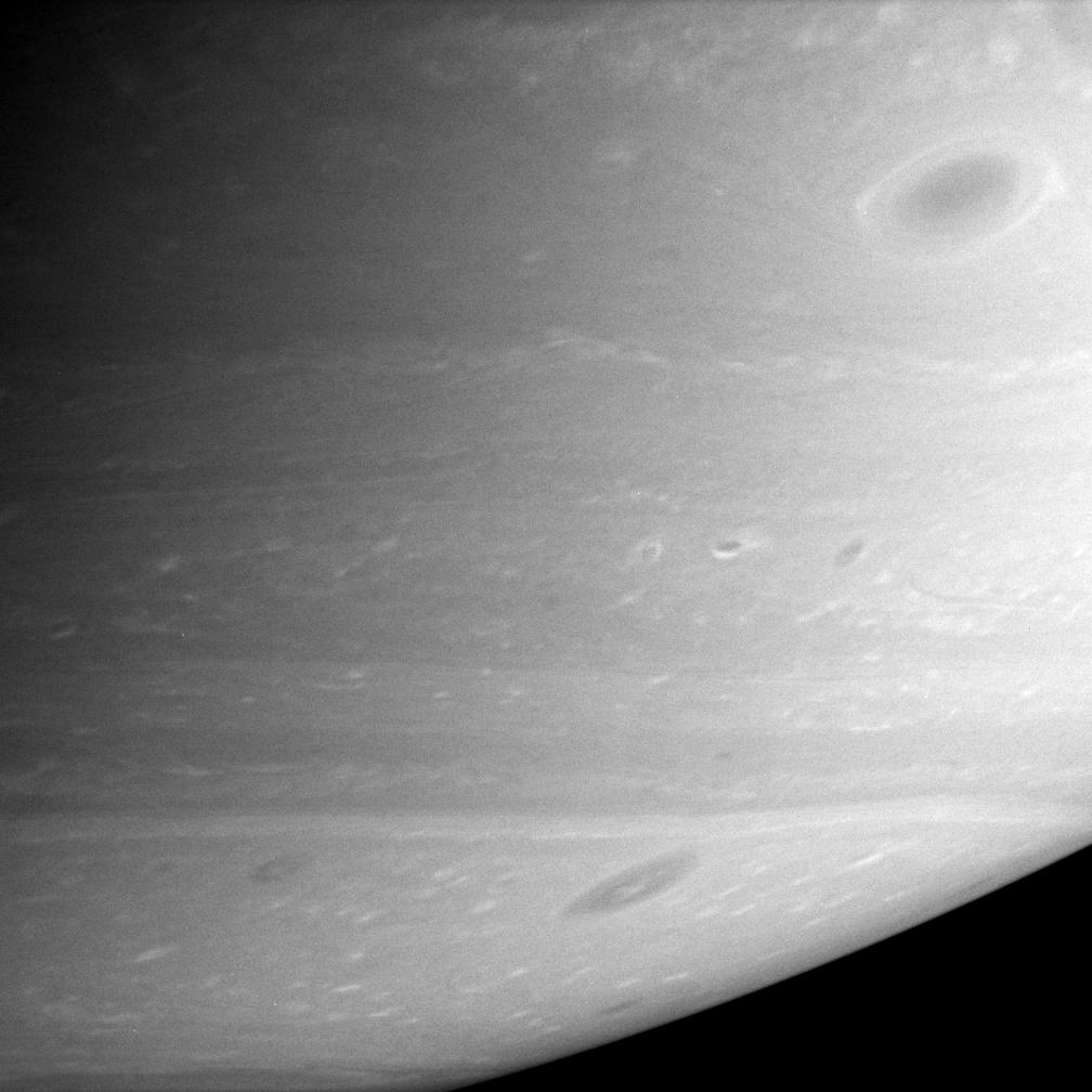 Close-up of Saturn showing dark vortices in the southern hemisphere
