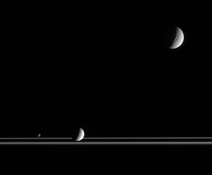 Saturn's rings, with the moons Tethys, Enceladus and Janus.