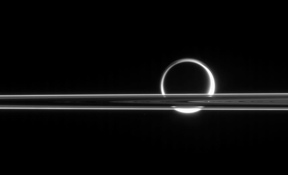 Titan shines beyond the rings like a brilliant ring of fire