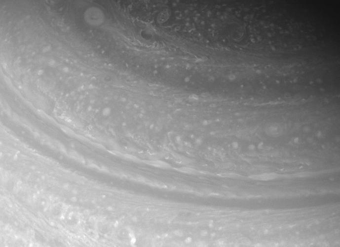 Diverse cloud forms shift and spin in the far northern reaches of Saturn