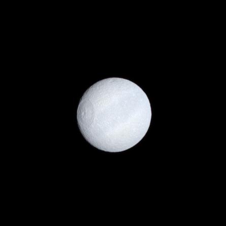 Tethys' dark equatorial band is seen in natural color on the moon's leading hemisphere.