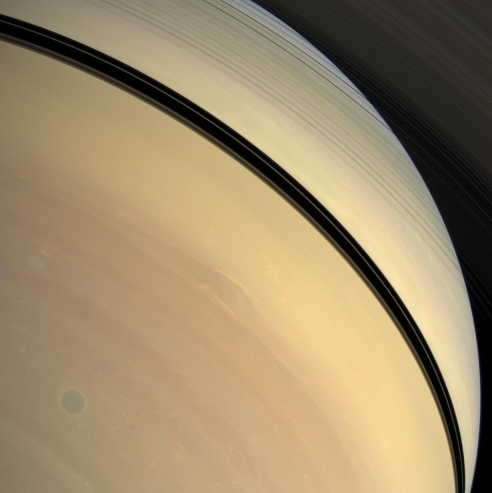Rendered in myriad hues, vivid details of Saturn's stormy atmosphere play out below the shadow of the rings.