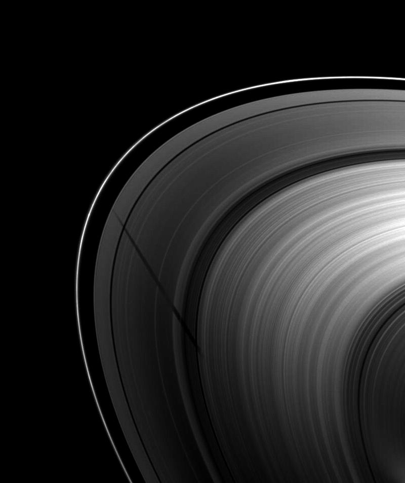 The shadow of the moon Tethys stretches across Saturn's A ring before fading into the B ring