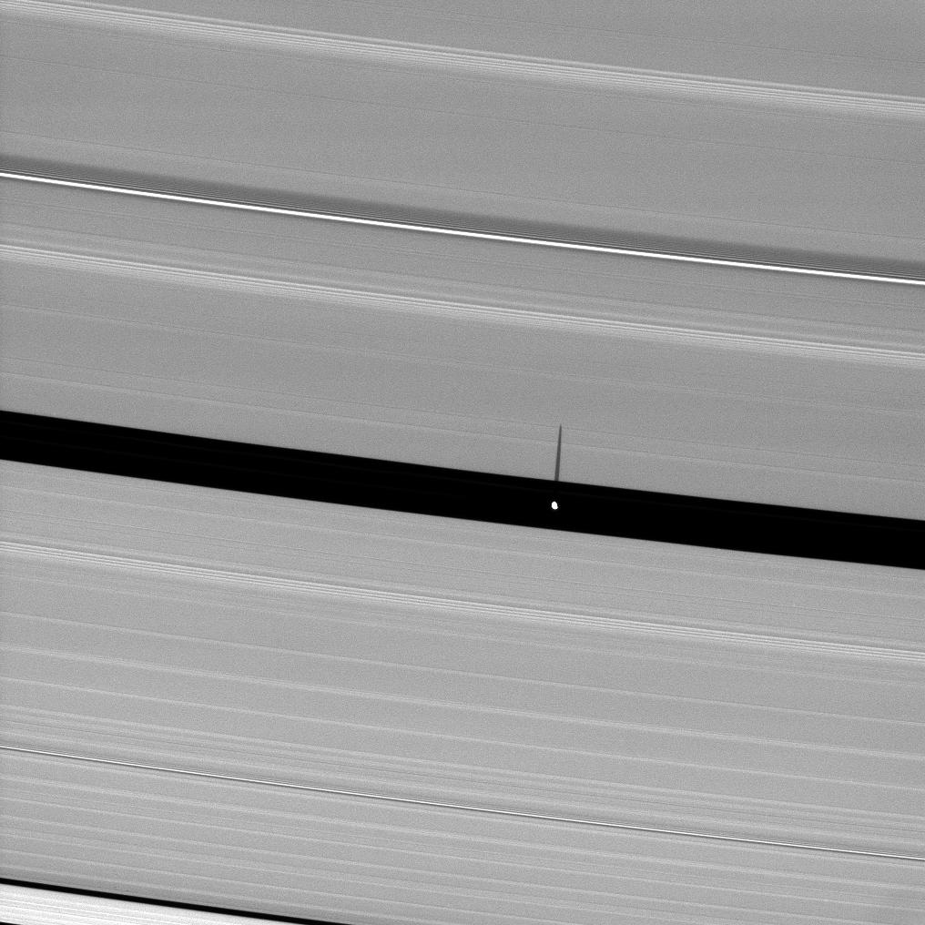 Saturn's moon Pan, orbiting in the Encke Gap, casts a slender shadow onto the A ring.