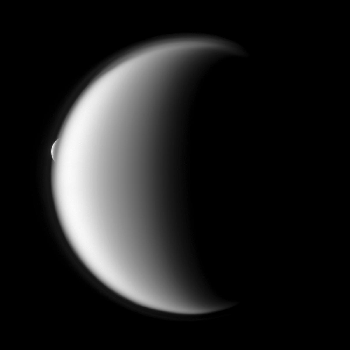 Rhea emerges after being occulted by the larger moon Titan