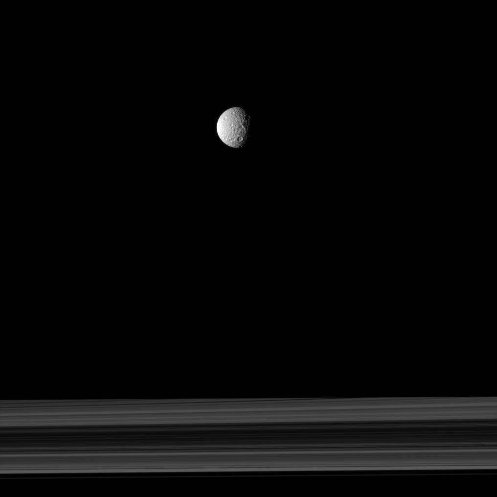The cratered moon Mimas and Saturn's rings