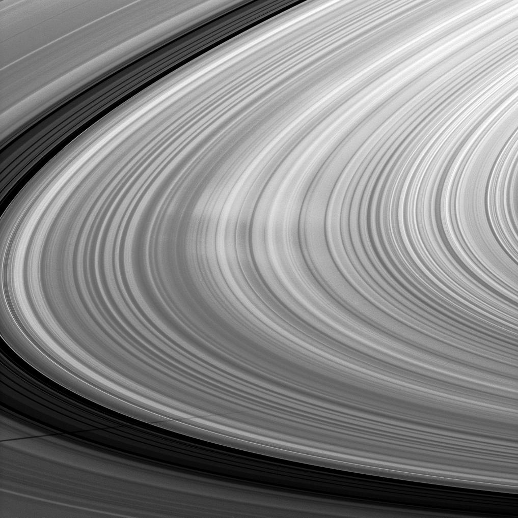 Bright spokes grace the B ring in this image which also includes the shadow of the moon Mimas and was taken about a month after Saturn's August 2009 equinox.