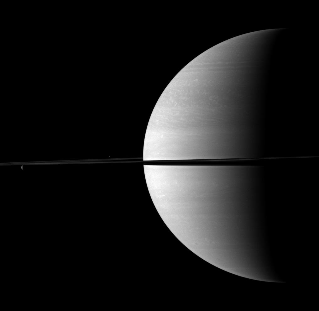 Rhea on the left; Enceladus near center; Saturn to the right