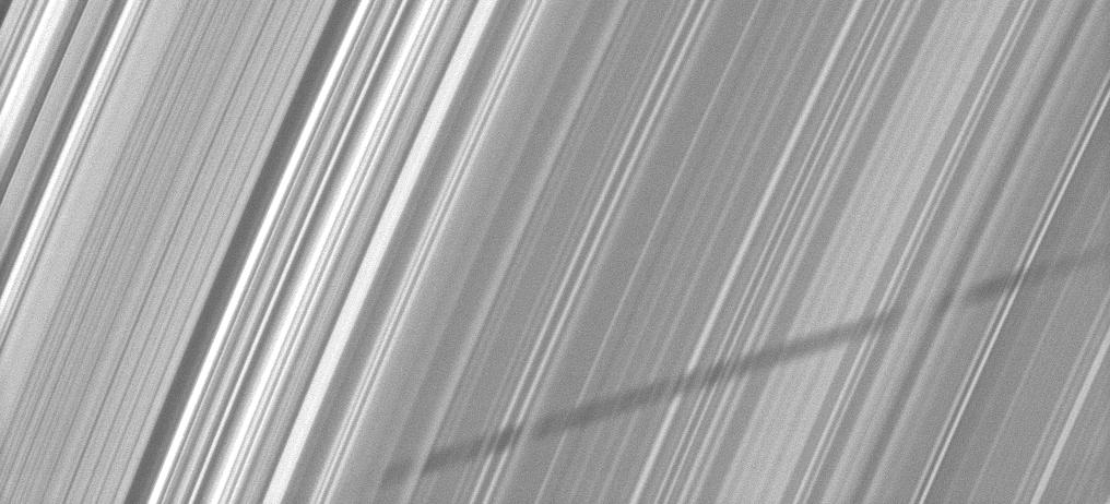 The shadow of Saturn's moon Epimetheus appears as if it has been woven through the planet's rings
