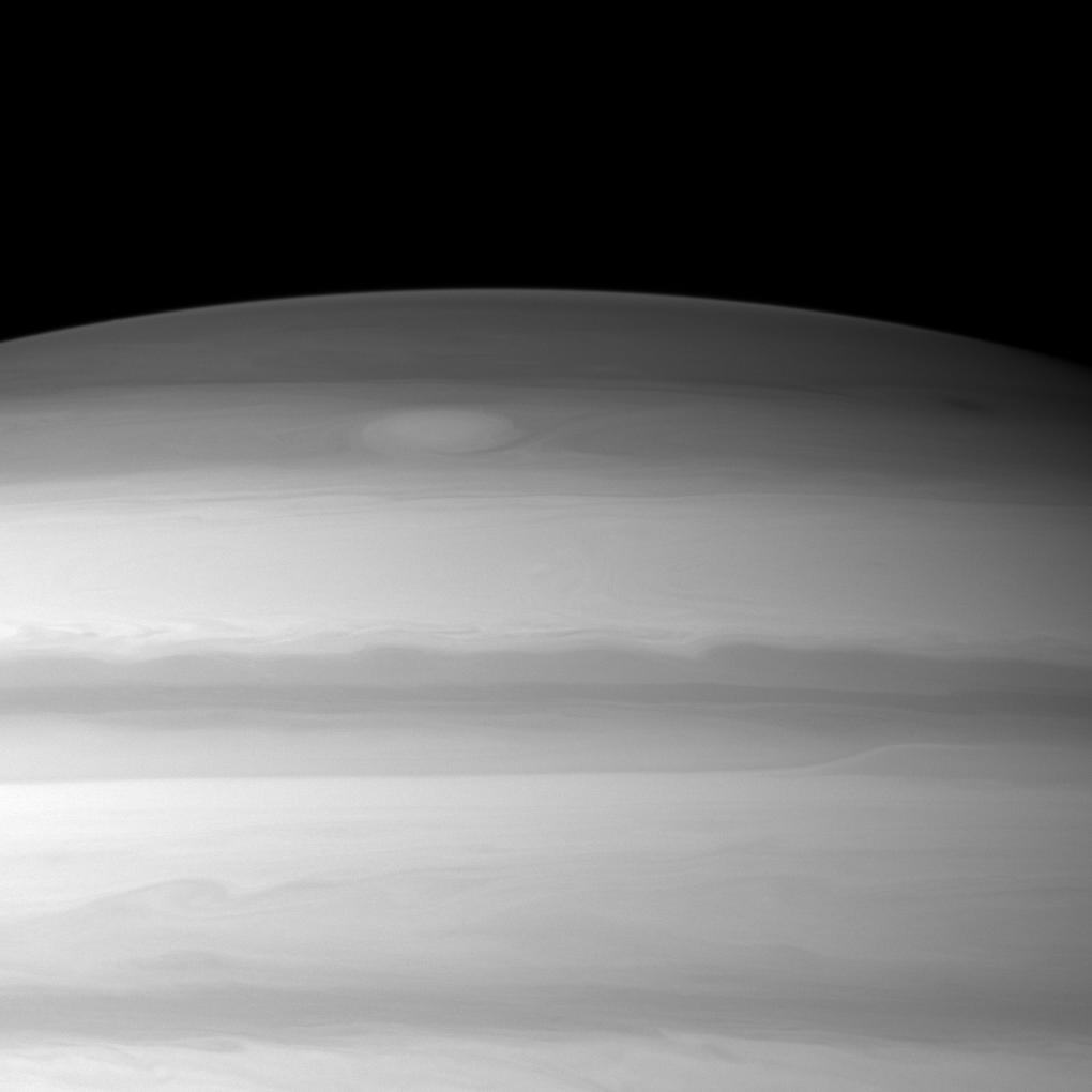 A large cloud formation swirls through the high northern latitudes of Saturn near the top of this Cassini spacecraft image.