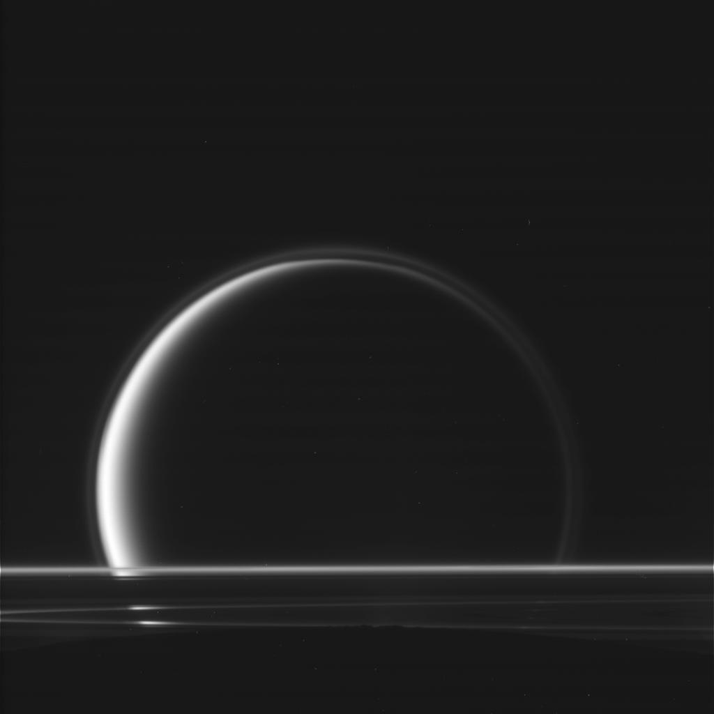 This raw, unprocessed image of Titan behind Saturn's rings was taken on May 18, 2010, by the Cassini spacecraft.
