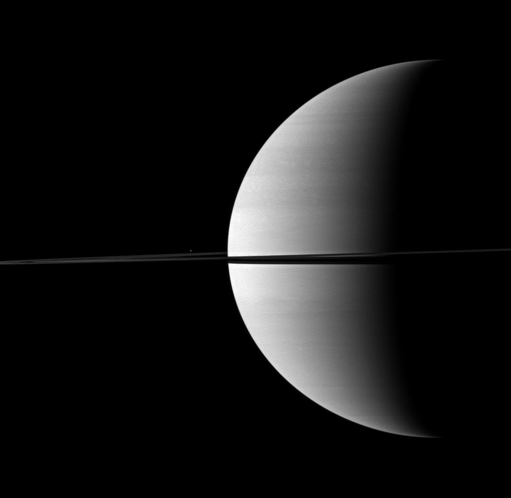 Enceladus is a small bright dot beyond Saturn's rings
