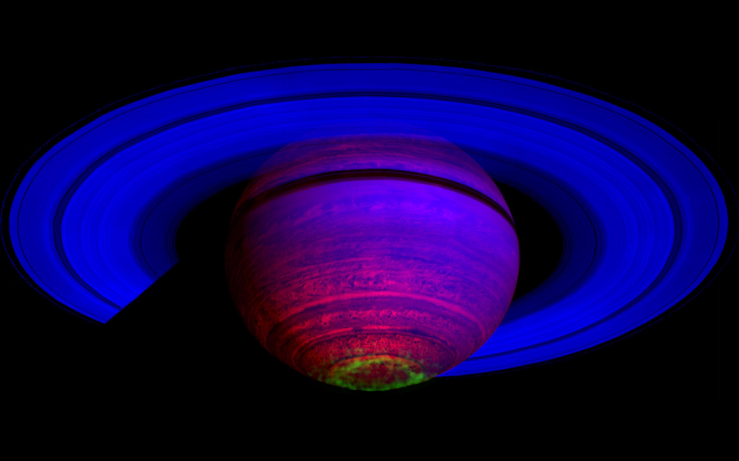 False-color composite image of the glow of auroras streaking out from Saturn's south polar region