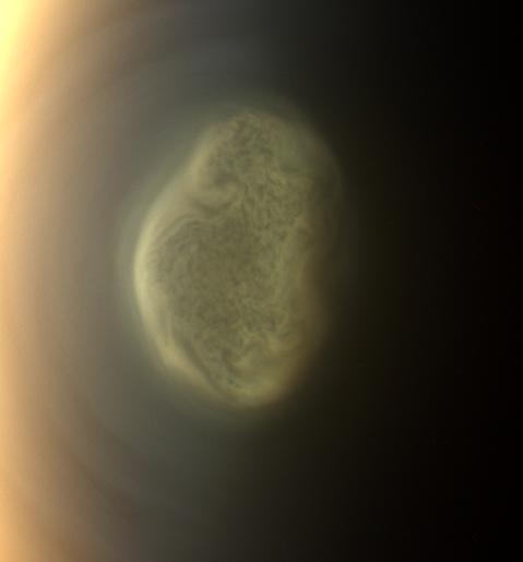 This true color image captured by NASA'S Cassini spacecraft before a distant flyby of Saturn's moon Titan on June 27, 2012, shows a south polar vortex, or a swirling mass of gas around the pole  in the atmosphere of the moon.