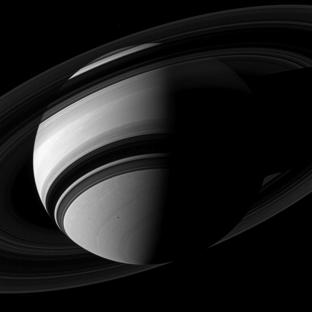 Janus, Saturn, its rings and Mimas' shadow