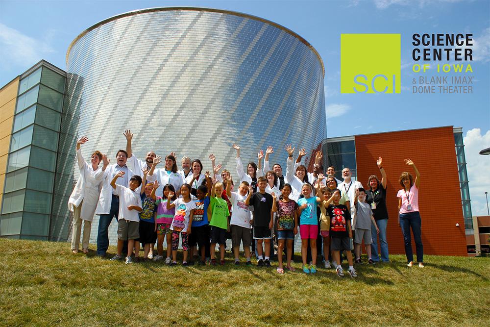 Students and staffers gather outside the Science Center of Iowa in Des Moines. They smile and wave in anticipation of their deep-space portrait session with NASA's Cassini spacecraft during the July 19, 2013, "Wave at Saturn" event. 