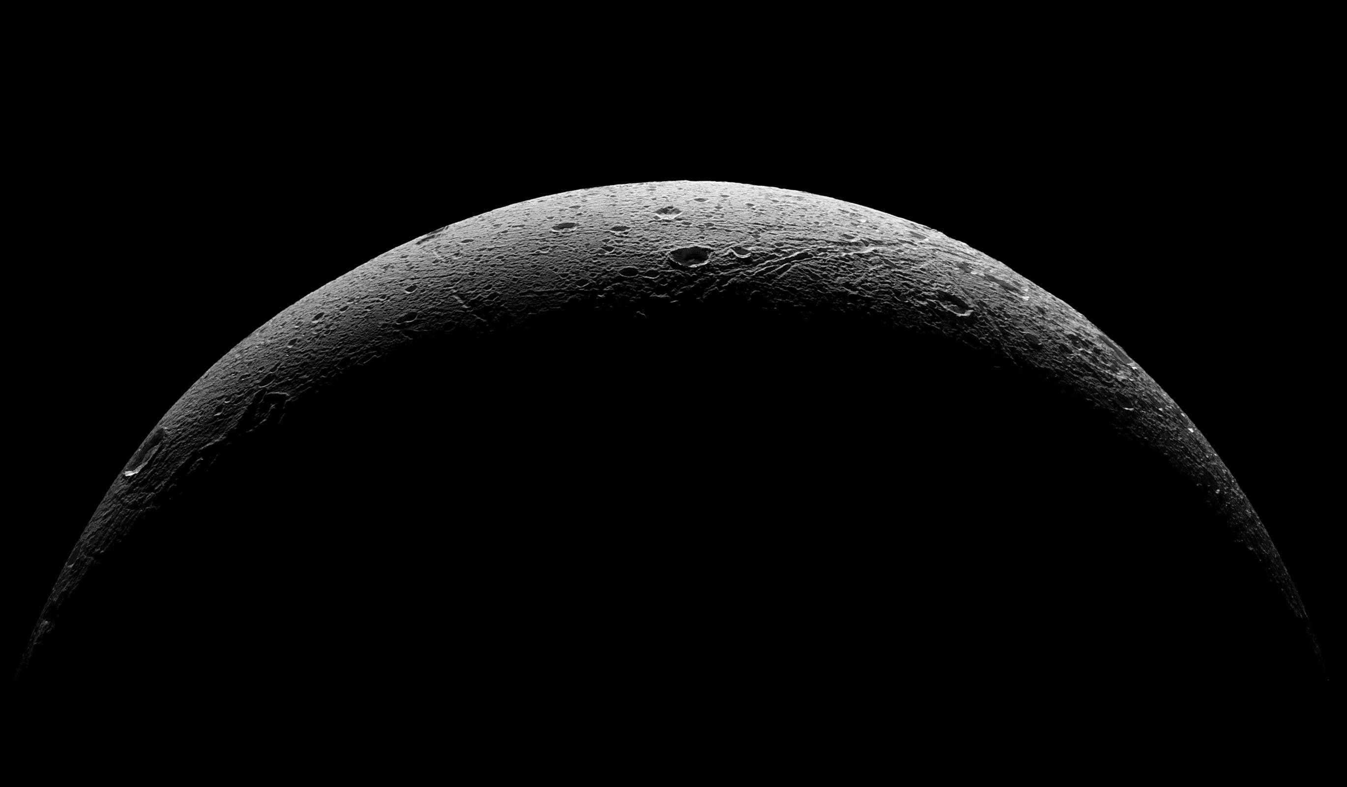 NASA's Cassini spacecraft captured this parting view showing the rough and icy crescent of Saturn's moon Dione following the spacecraft's last close flyby of the moon on Aug. 17, 2015.